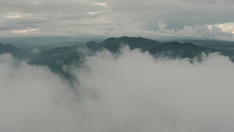 Drone-aerial-flying-over-clouds-revealing-a-beautiful-landscape-with-mountains-in-Guatemala