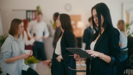 Young-businesswoman-using-tablet-PC-in-office.