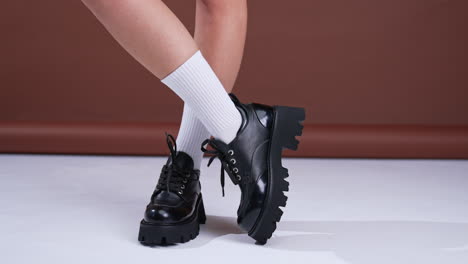 stylish black platform shoes on women's legs