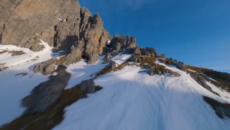 epic austrian winter mountain filmed by an fpv drone at sunrise