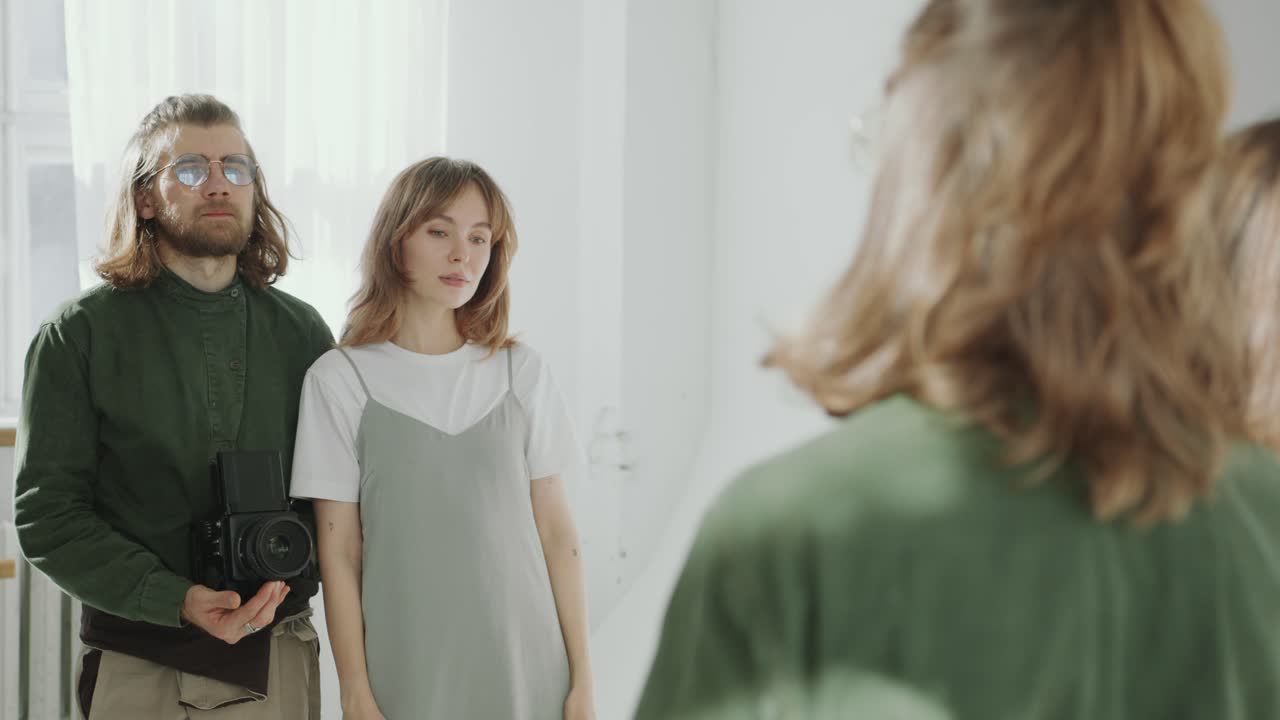 Female Model and Photographer Taking Pictures in front of Mirror in Studio