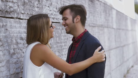 friends hugging and kissing on street