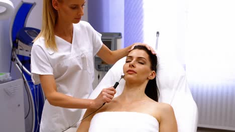 doctor performing laser hair removal on patient