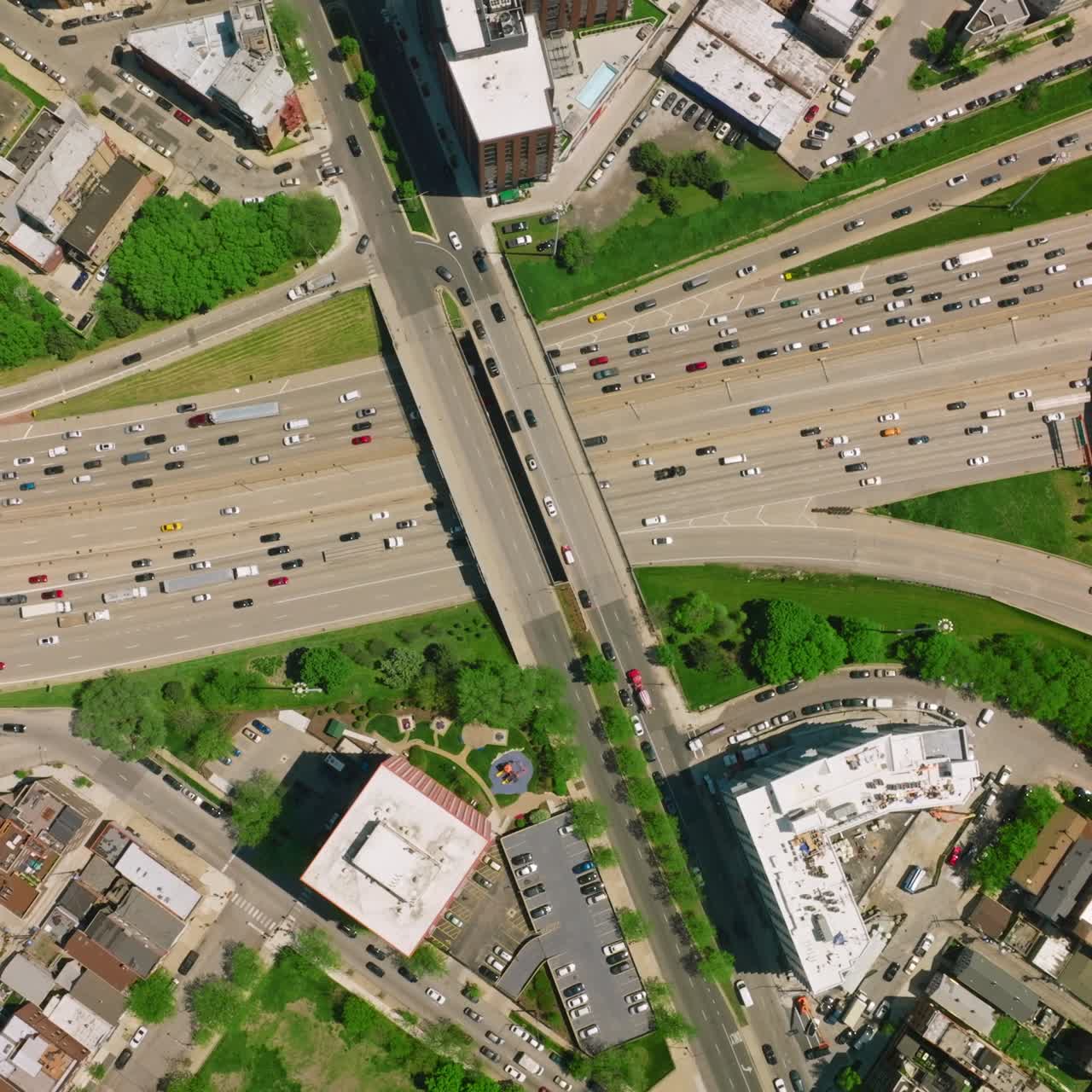 Crazy traffic on the busy roads of Chicago city. Numerous cars moving along diverse motorways. Top view