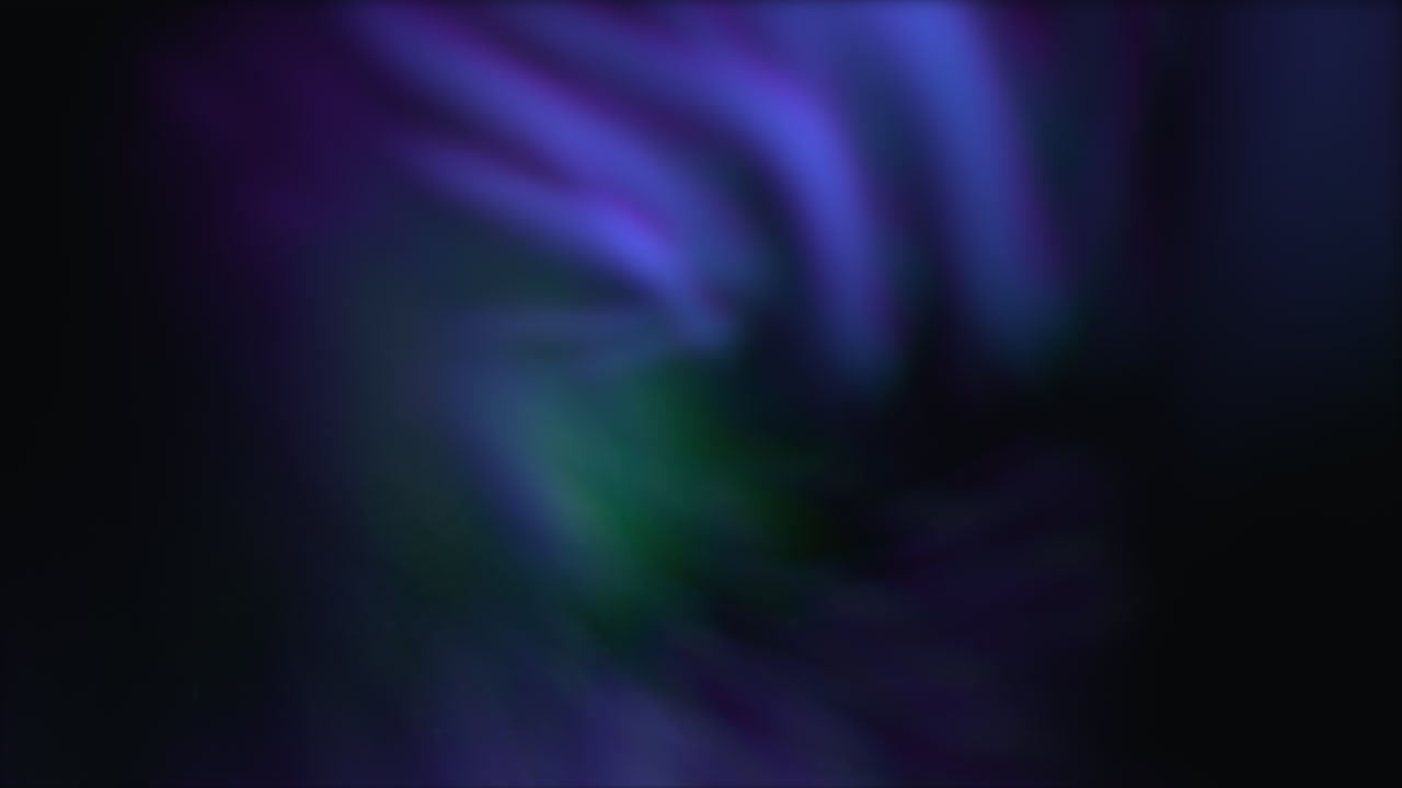 A vibrant, swirling vortex of purple, blue, and green hues spinning rapidly, creating a mesmerizing blur effect. The dynamic colors blend magnificently to form a captivating, swirling spectacle
