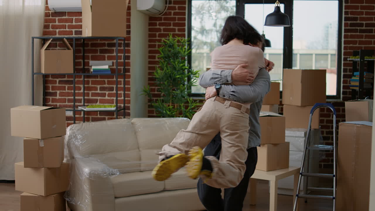 Married couple hugging and showing gratitude to move in apartment flat