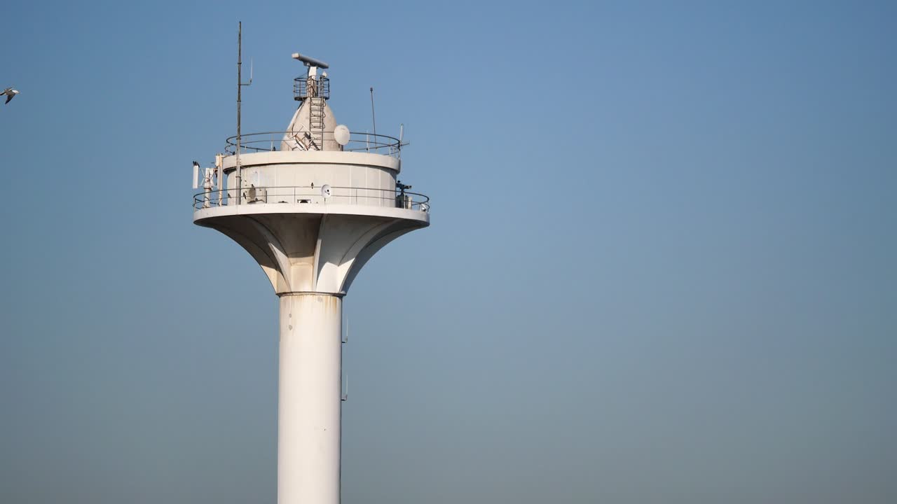 White Navigation Tower Against a Clear Blue Sky