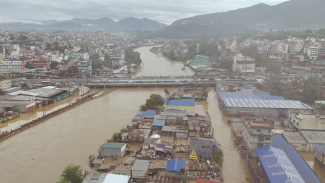 drone shot of bagmati river flooding kathmandu, nepal, devastating unmanaged urban city and citizens habitation dreadful situation, triggered by a cloudburst, severe impact of climate crisis