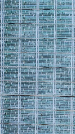 aerial view of glass greenhouses. metal frame construction with glass. vertical video
