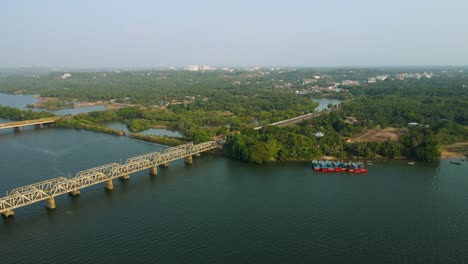 aerial drone shot of a train moving across a railway bridge above the ocean