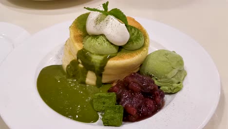 souffle pancake, matcha flavor with red bean mashed and green tea ice-cream, japanese style in hong kong cafe restaurant