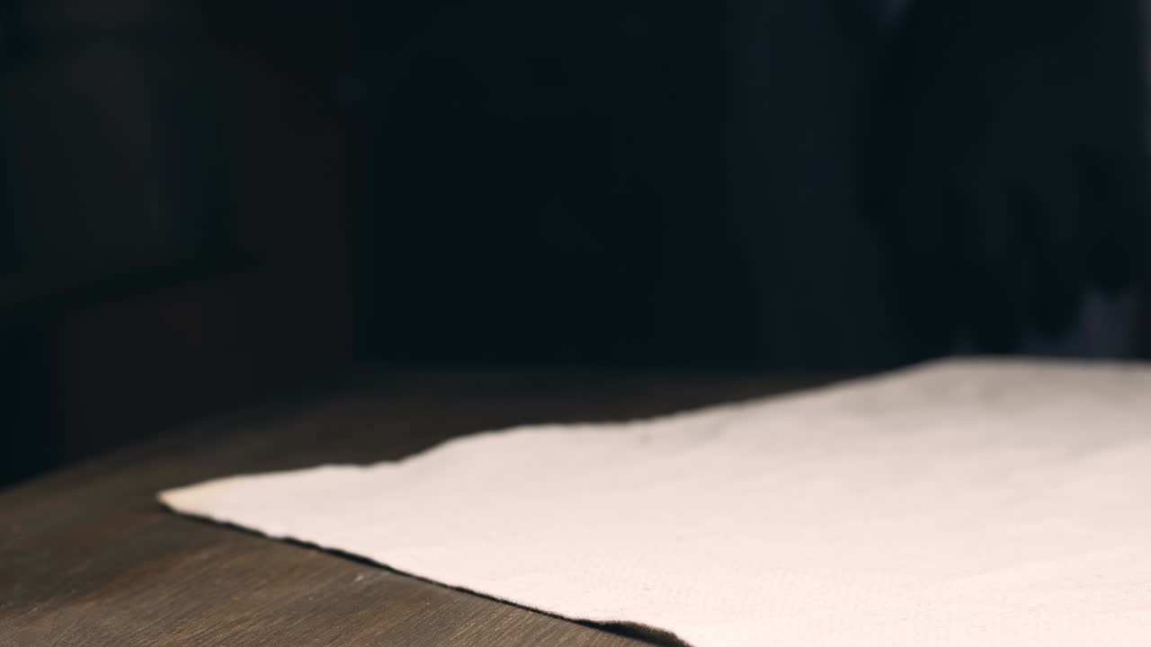 Baker puts freshly baked bread on the table.