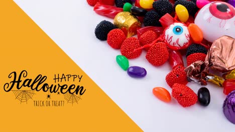 Animation-of-happy-halloween-text-over-sweets