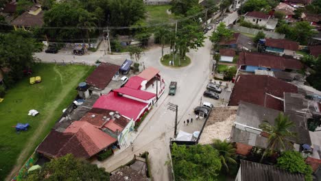 aerial view tracking people on the streets of the barra do sahy town, in sunny brazil