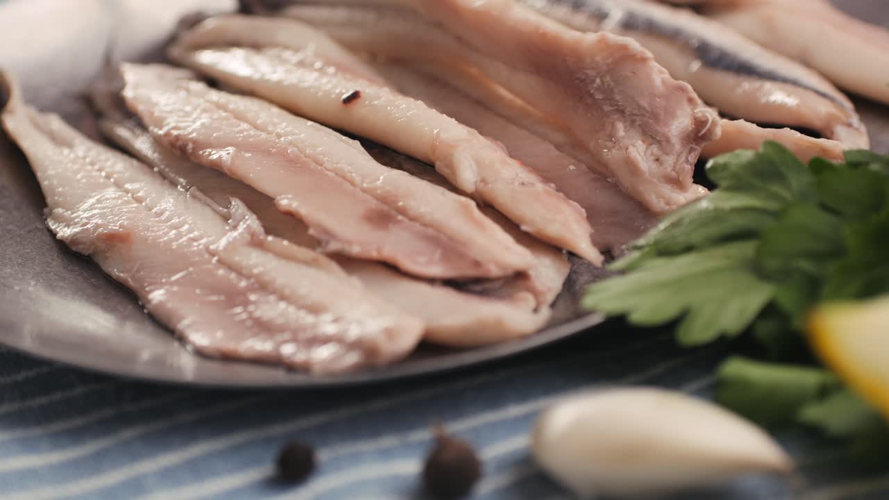 Fresh Sea sardines and Anchovy Fish and Mullus On Display On Ice On Market Store Shop. Seafood Fish Background, close up stand of small salty white fish.