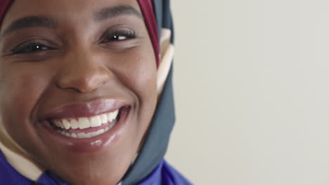close up portrait beautiful black muslim woman laughing cheerful enjoying success pretty african american female wearing hijab headscarf on white background