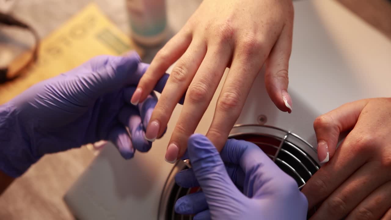 Woman getting a french manicure