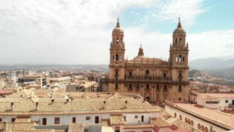 Spain-Jaen-Cathedral,-Catedral-de-Jaen,-flying-shoots-of-this-old-church-with-a-drone-at-4k-24fps-using-a-ND-filter-also-it-can-be-seen-the-old-town-of-Jaen