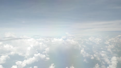 view of sky with white puffy cloud and sun light above sky