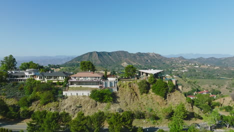 aerial luxury real estate, drone shot of hollywood hills homes on beautiful sunny california day