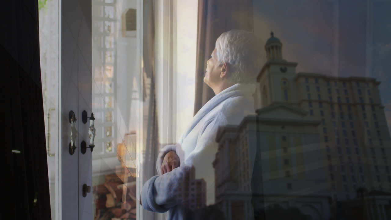 In robe, elderly person gazing out window with cityscape reflection animation