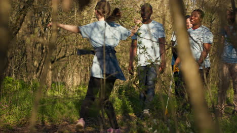 Cheerful-proud-group-of-activists-finishing-litter-cleanup-in-a-forest,