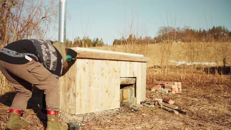 man building his homemade hot tub outdoors - close up