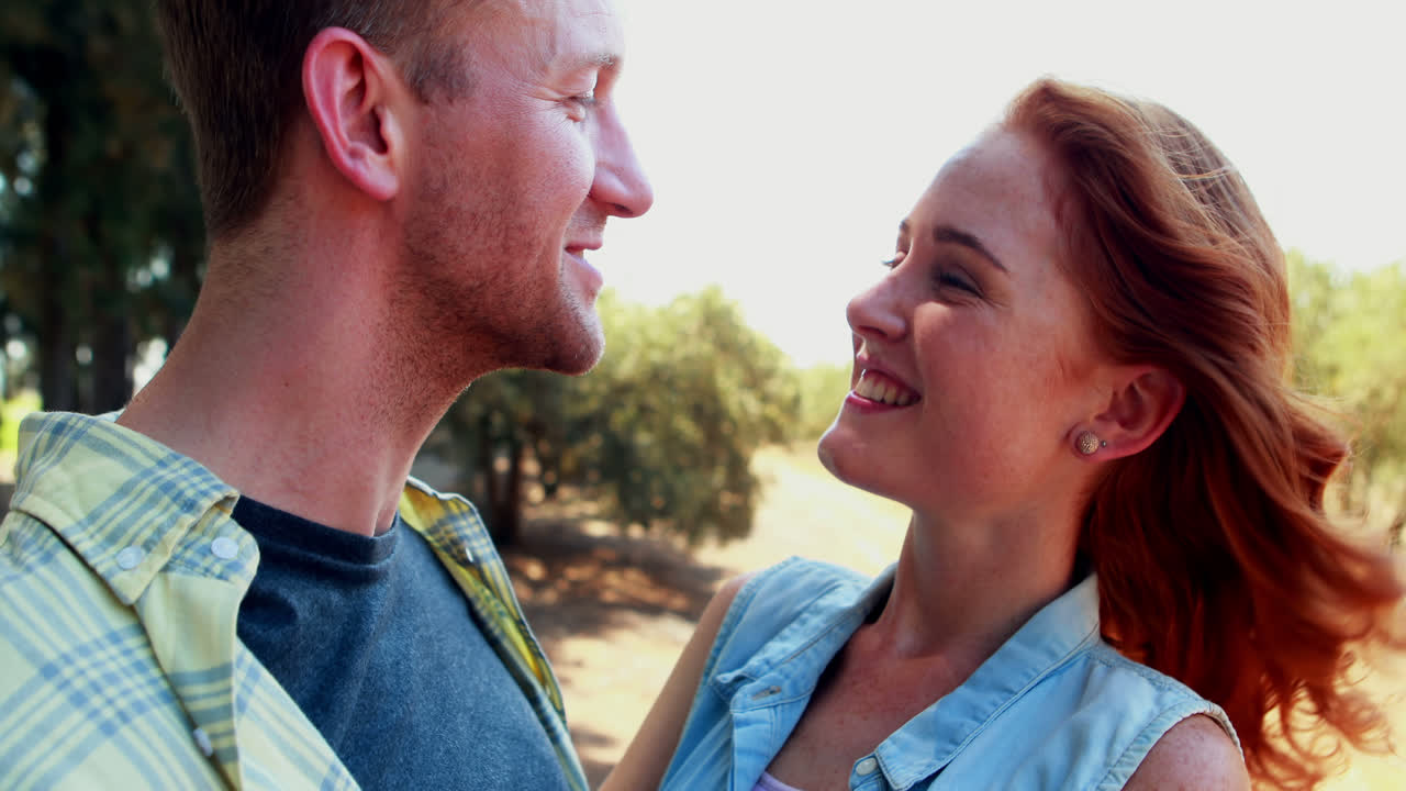 Happy couple interacting with each other in olive farm 4k
