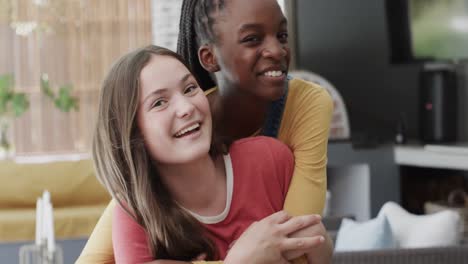 Portrait-of-happy-diverse-teenage-female-friends-embracing-and-smiling-to-camera-in-slow-motion