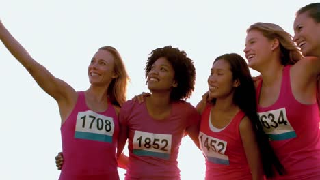 runners supporting breast cancer marathon and taking selfies