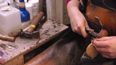 Bespoke-Shoemaker-Pinning-Leather-Together-To-Make-Shoe