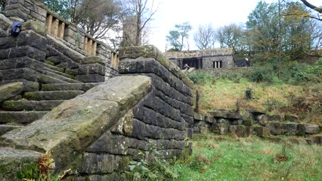 Stone-moss-covered-staircase-ruins-Autumn-woodland-Rivington-ornamental-terraced-gardens-wilderness-slow-left-dolly