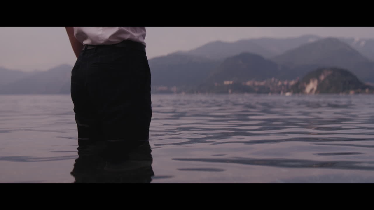 Person Smoking by the Lake