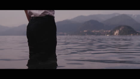 person smoking by the lake
