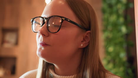 close up of lady eating chocolate cake with fork in cozy cafe setting, her mouth open in anticipation and soft blur background enhances warm mood and focus on enjoyment of sweet indulgent bite