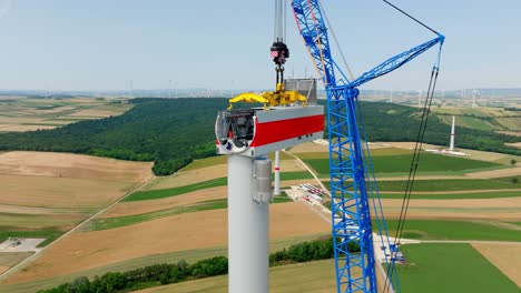 head of windmill construction in agricultural fields - drone shot