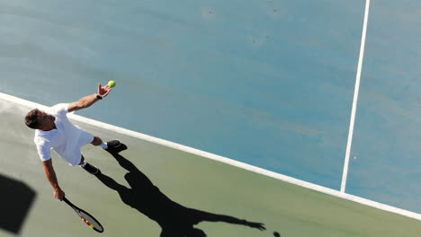 caucasian male tennis player holding racket and playing tennis at court