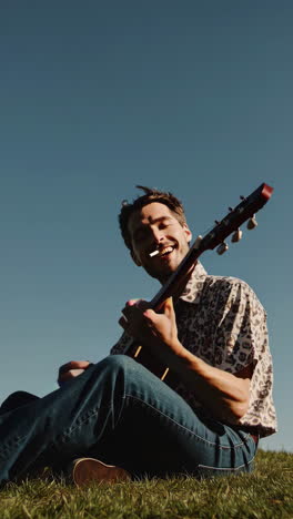 man playing guitar outdoors