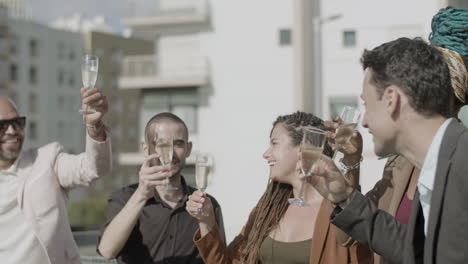 slow motion of happy coworkers clinking glasses of champagne