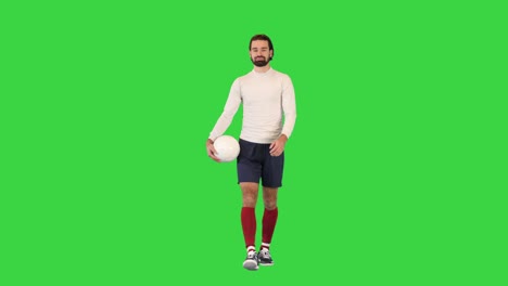 soccer player with a bag in hands walking on a green screen, chroma key