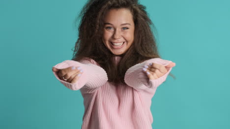 Caucasian-curly-haired-woman-hugging-in-front-of-the-camera.