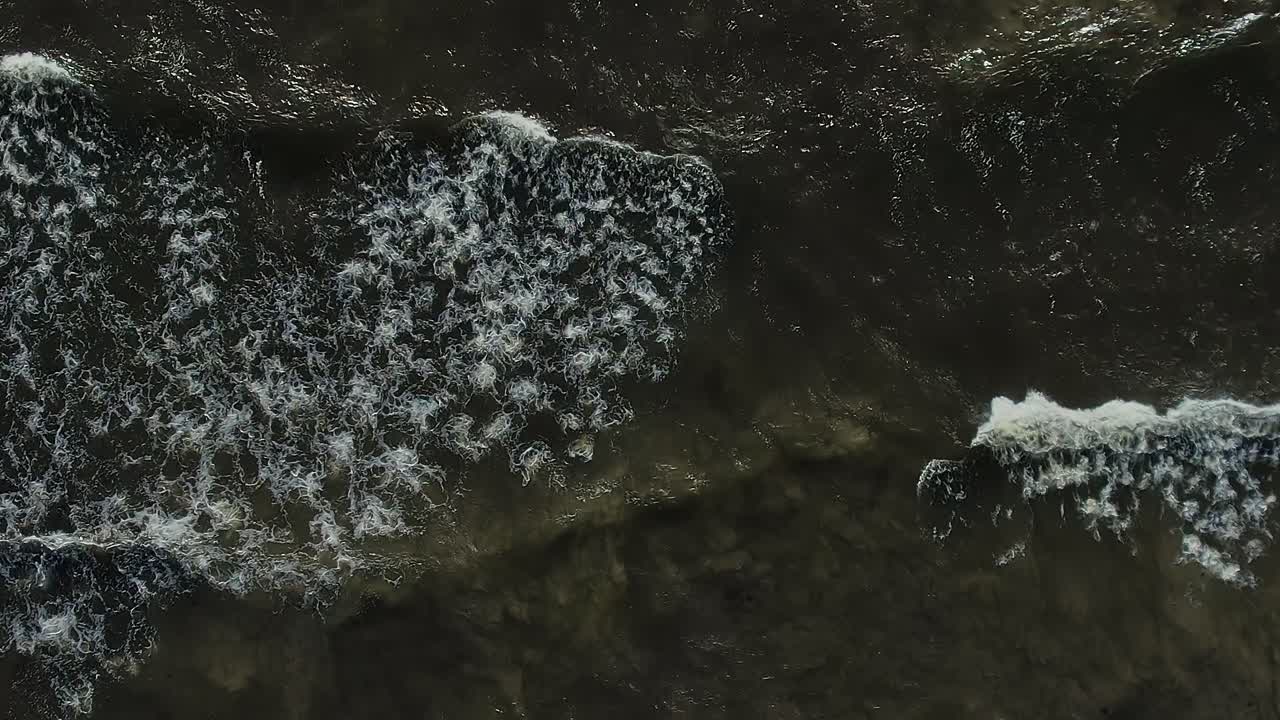 Waves breaking on the shore of the Baltic Sea at midday