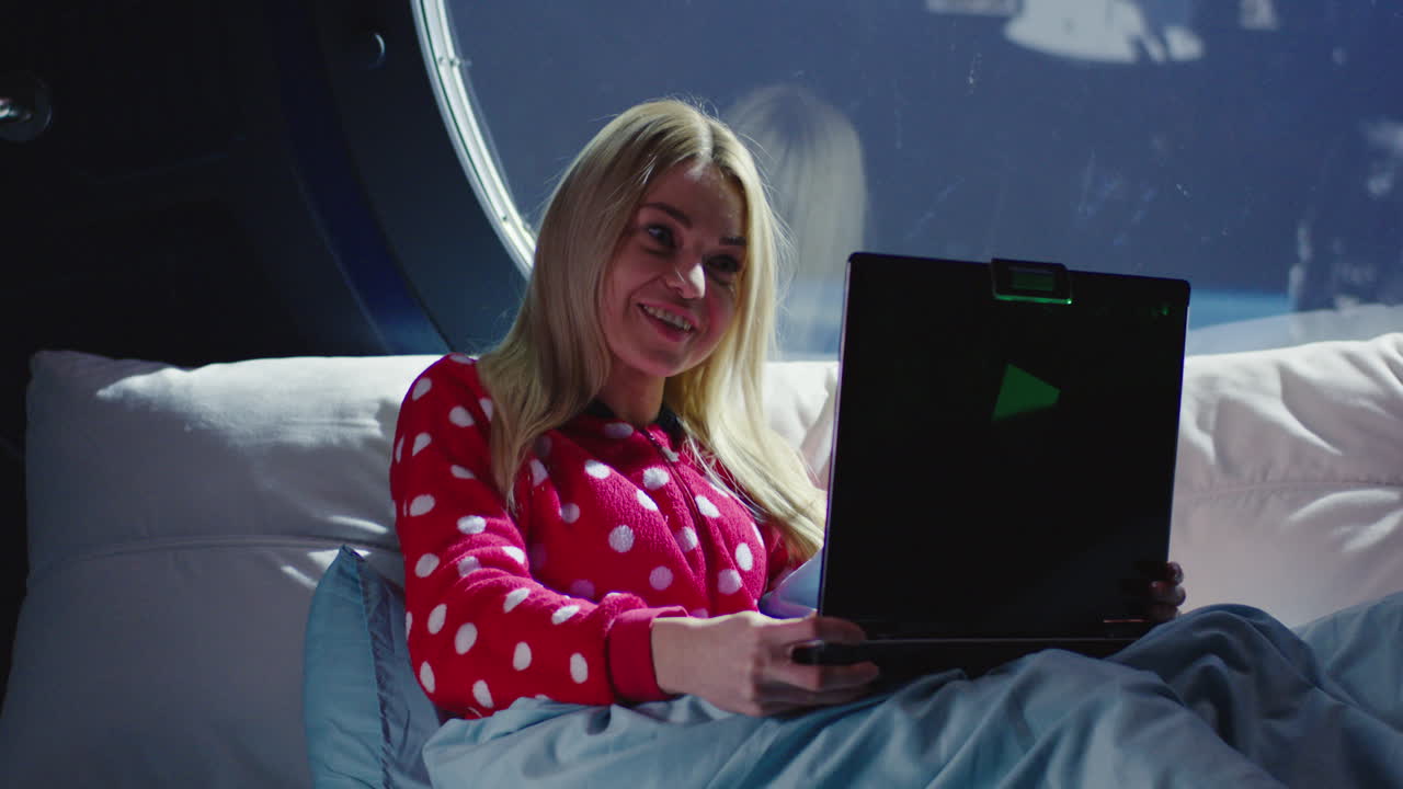 Woman Using Laptop in Spacecraft