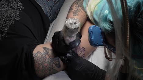 A timelapse video capturing a tattoo artist working from start to finish, carefully inking a detailed design on a client’s arm.