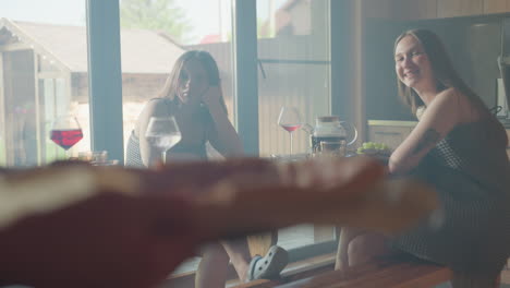 beautiful moment with colleagues having a good time together, smiling and enjoying conversation over pizza, cozy indoor setting, sunlight streaming in through windows