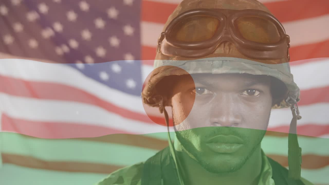 Soldier gripping backpack strap initiating Nigerien flag overlay while displaying American flag