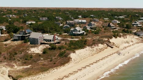 waterfront beach houses on shore of cape cod, sunny summer day, aerial