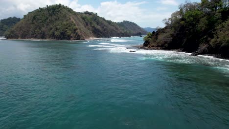 coastal island and waves in costa rica - herradura bay and herradura island