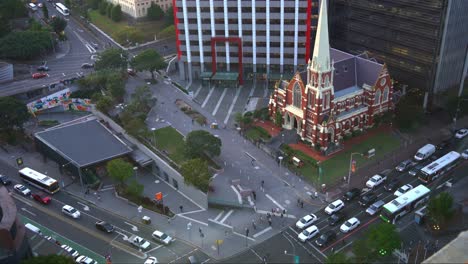 Establishing-shot,-birds-eye-view-capturing-architectural-details-of-historical-landmark-Albert-street-uniting-church-from-above-with-traffics-on-Ann-street-and-Roma-street,-downtown-Brisbane-city