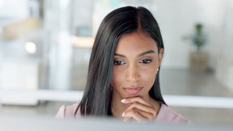 thinking businesswoman working on a computer